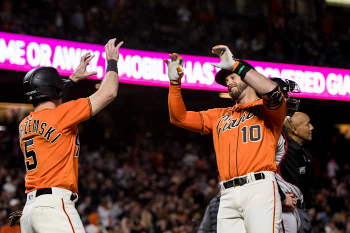SF Giants third baseman Evan Longoria celebrates with Mike Yastrzemski after hitting a grand slam.